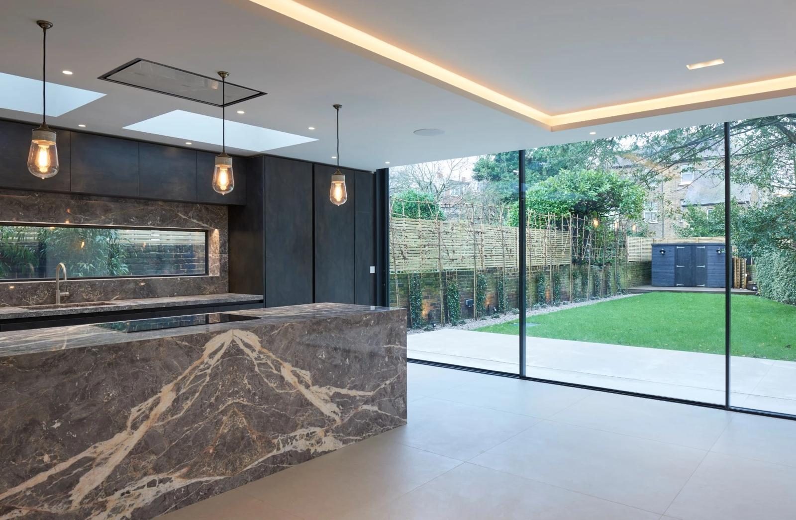 Kitchen opened to the garden through minimal-frame sliders