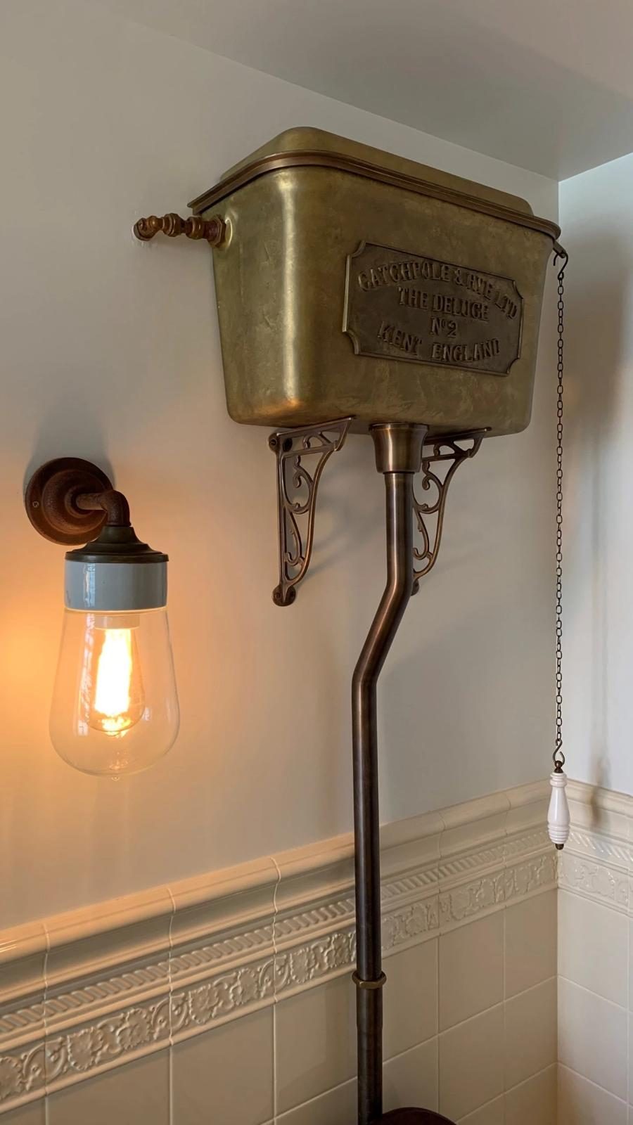 Brass high-level cistern — the detail work carried into the bathrooms