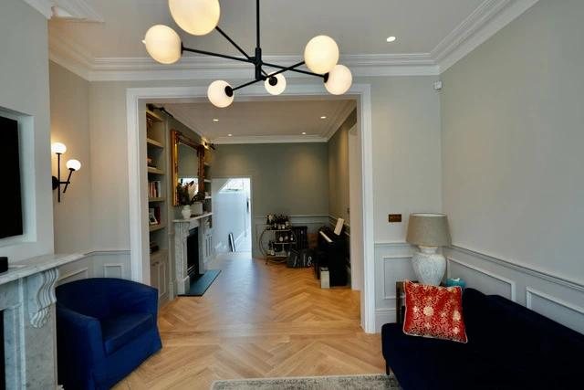 Living room — herringbone flooring, panelling and joinery