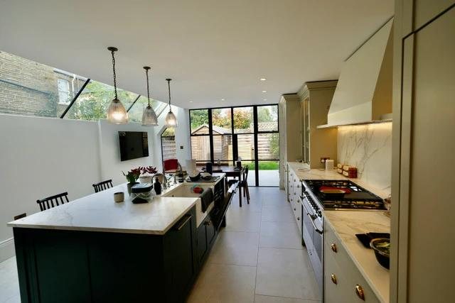The new kitchen — painted cabinetry, stone-effect worktops and a range cooker