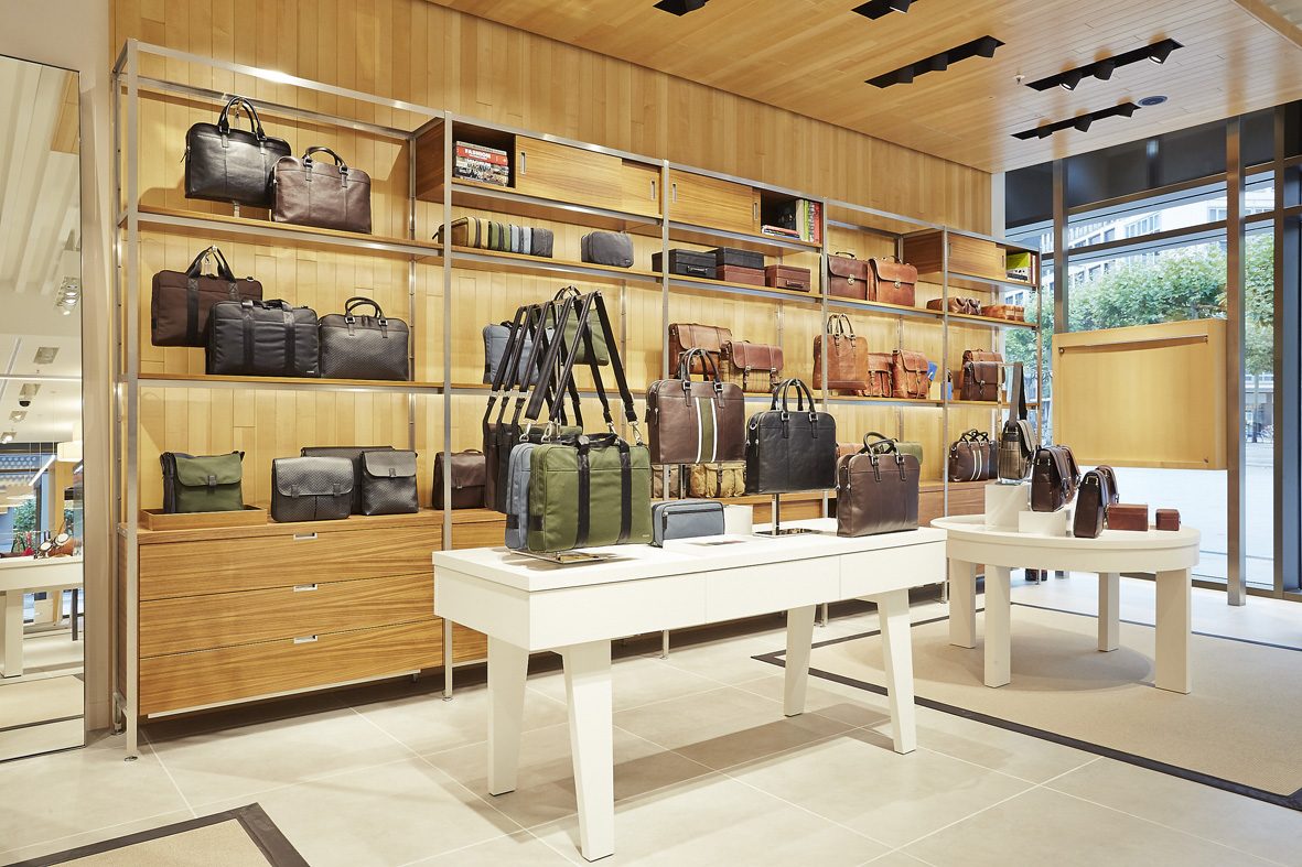 Steel and timber shelving system to the leather wall