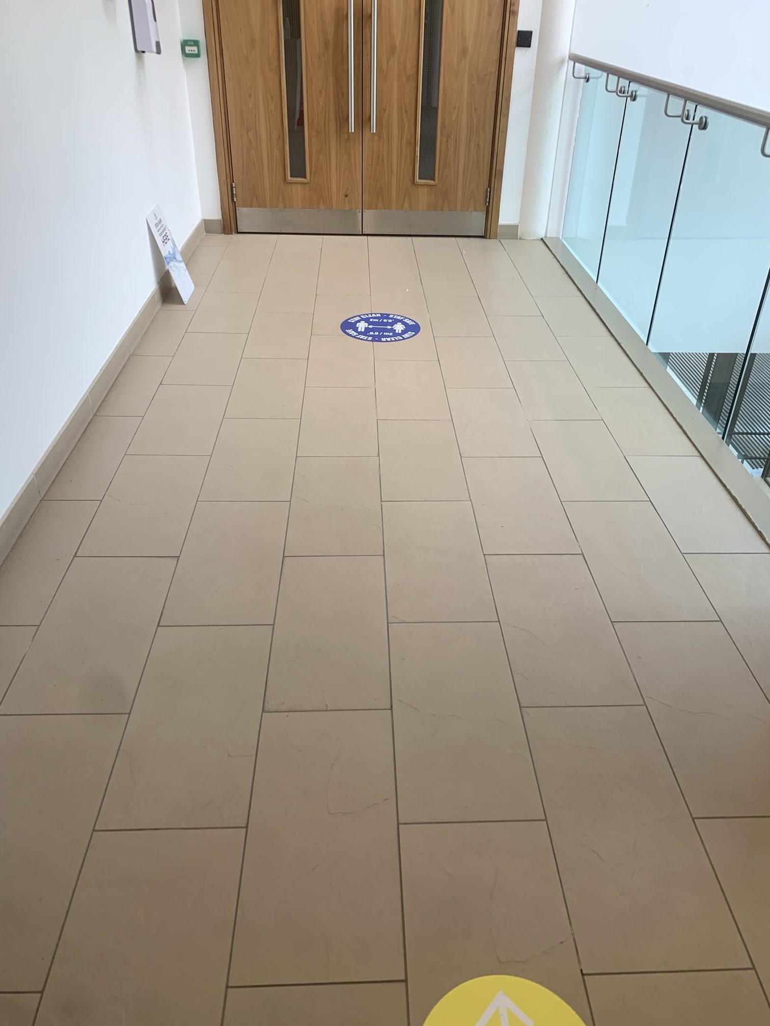 Before — the existing tiled walkway and one-way floor graphics