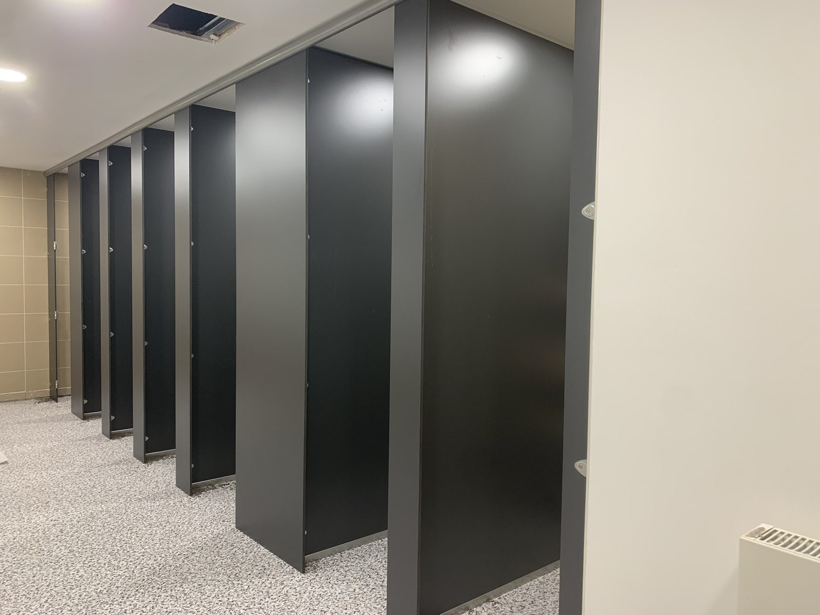 Cubicle system going in over new flecked safety vinyl