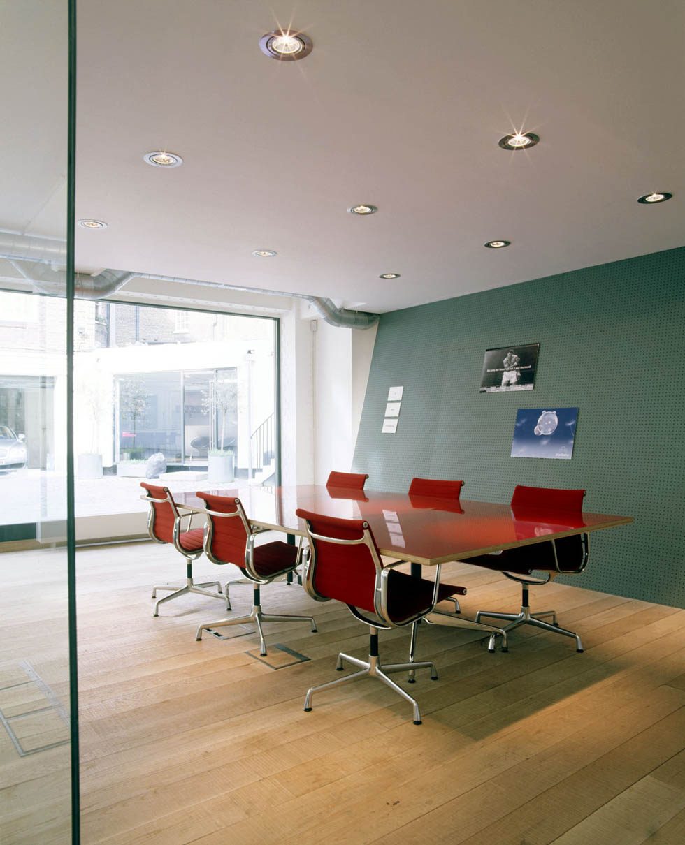 Boardroom behind frameless glass, facing the street