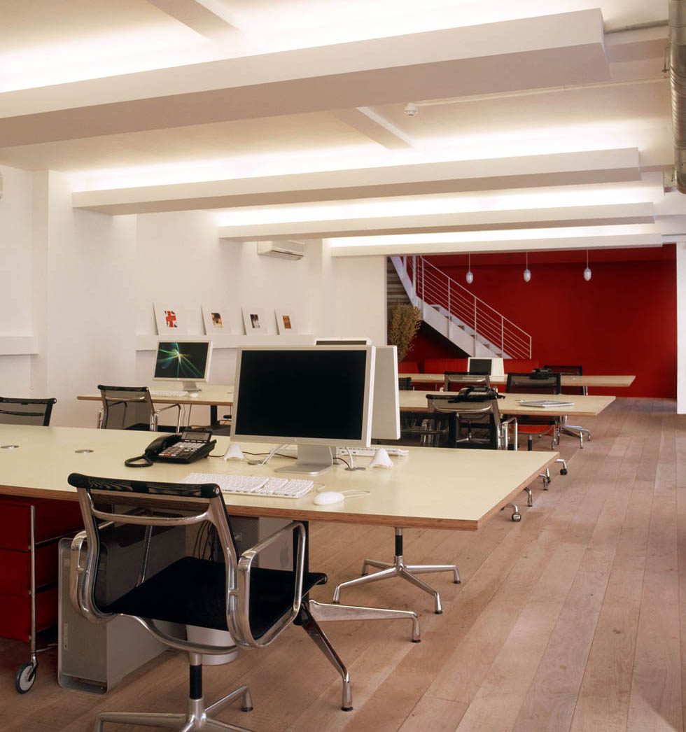Open plan with recessed linear lighting and oak flooring