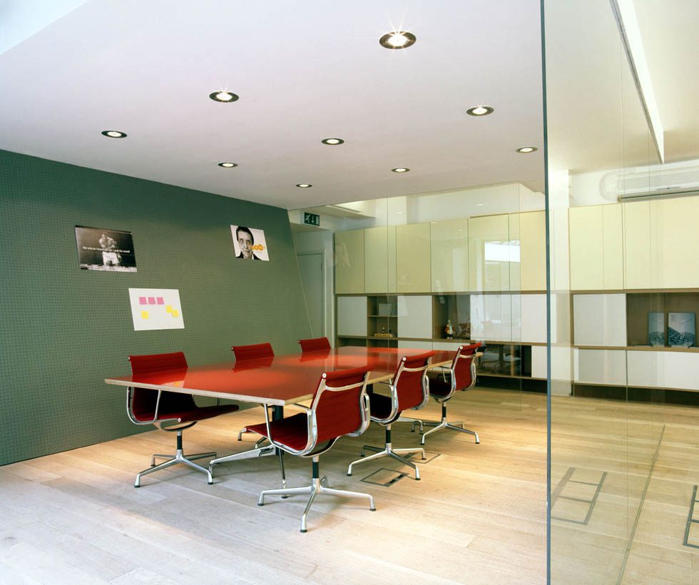 Double-height stair with the red wall running through it