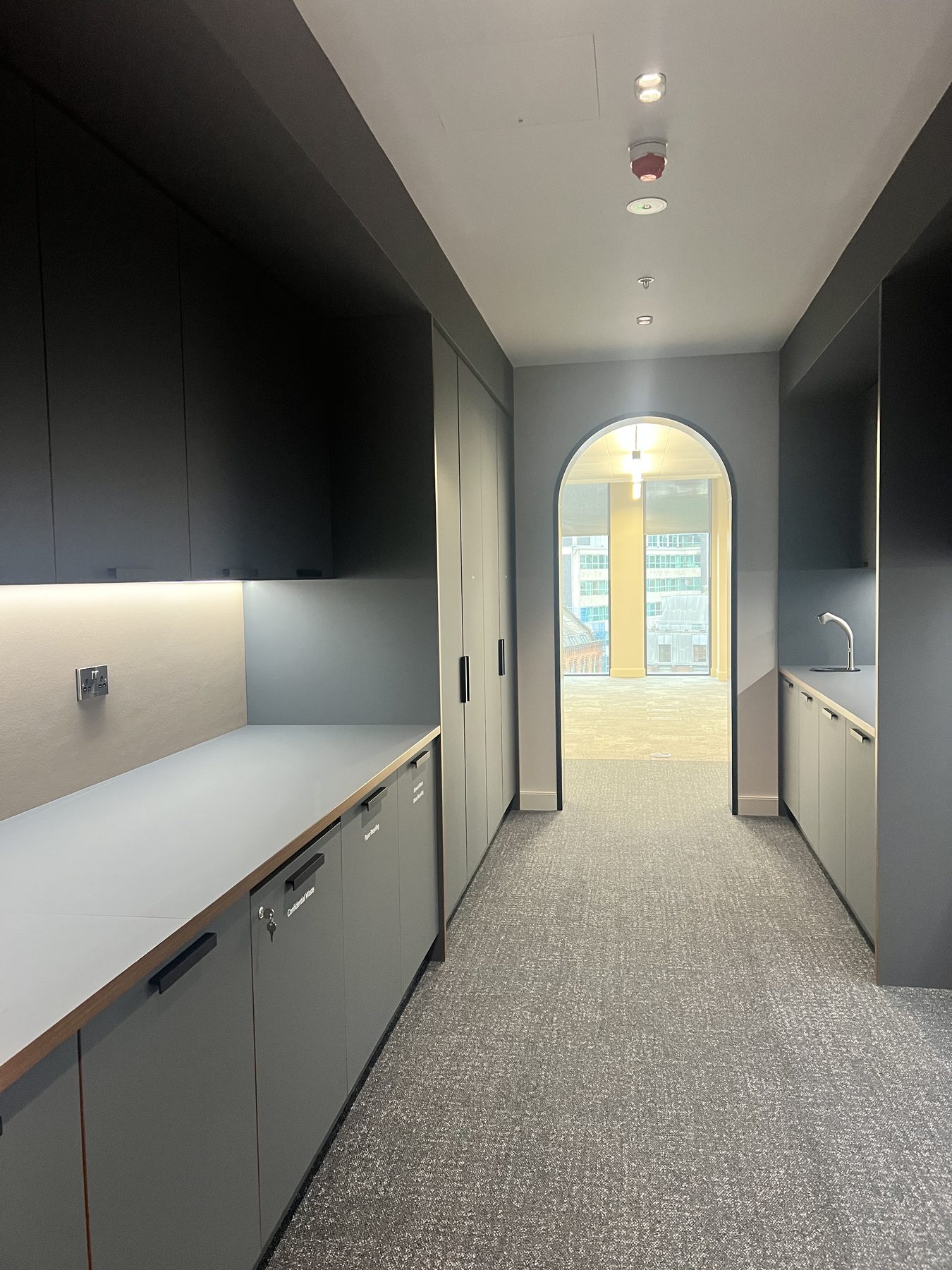 Copy and utility area behind an arched opening